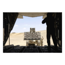 A forklift loads cargo onto a C-130 Hercules Photograph
