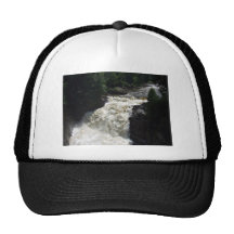 A waterfall with trees and rocks mesh hat