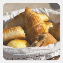 A wicker breakfast basket with croissants, and stickers