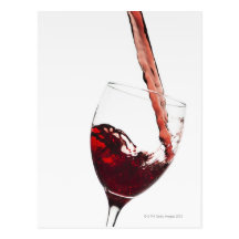 Close up of red wine being poured into glass on post card