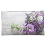 lavender-coloured flowers on old music cosmetic ba