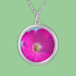 pink petunia flower in blue background. necklaces