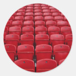 Red seats at football stadium round sticker