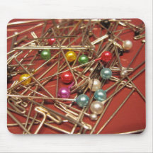 scatter of colourful sewing pins mouse pads