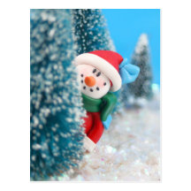 Snowman hiding or peeking from behind a tree post cards