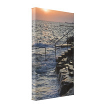 Sunset and flow on the rocky beach stretched canvas prints