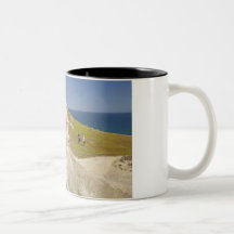 Tourists on cliff top at Tunnel Beach Coffee Mugs