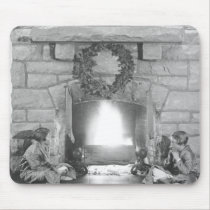 Two girls sitting by a fireplace at Christmas mousepads