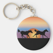 Two horses running against a sunrise keychain