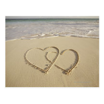 Two overlying hearts drawn on the beach post cards