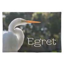 White Egret text backlit looking right against placemats