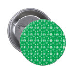 White snowflakes on green buttons