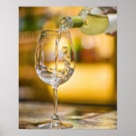White wine is poured from bottle in restaurant. print