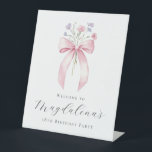 18th Birthday Party Pink Bow Wildflower Welcome Pedestal Sign<br><div class="desc">A pretty blush pink coquette bow is accented by small,  dainty blue and pink wildflowers. Three lines of text below let you personalise the sign. All text is editable.</div>
