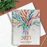 2023 Personalised Planner<br><div class="desc">This unique Planner is decorated with a brightly coloured mosaic tree. Customise it with your name and year. To edit further use the Design Tool to change the font, font size, or colour. Because we create our artwork you won't find this exact image from other designers. Original Mosaic © Michele...</div>