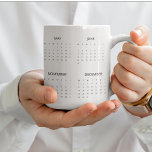 2025 Calendar Mug | Stylish & Functional<br><div class="desc">Stay organised every day with this 2025 calendar mug, perfect for your morning coffee or tea. Featuring a sleek and functional full-year calendar design, this mug is both practical and stylish. Whether at home or in the office, it serves as a quick date reference while adding a touch of charm...</div>