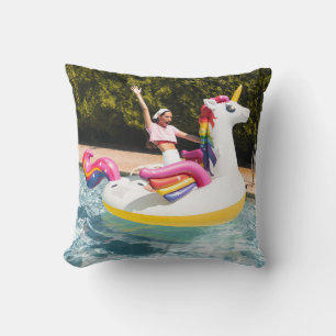 2 children riding on white and red inflatable boat cushion