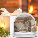 2 Photos Love Heart Name Simple Modern Script Snowglobe<br><div class="desc">Celebrate life’s sweetest moments in a swirl of snow, because every photo deserves a little magic. Capture the holiday magic with this personalised snow globe, featuring a white, elegant script font 'Love' with a heart image at the end, an option to add the couple's names and two personal Photos (one...</div>