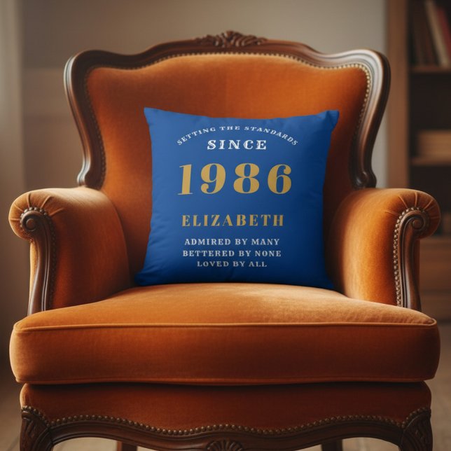 40th Birthday 1986 Add Name Blue Gold Personalized Cushion (1986 blue throw pillow on an orange chair)
