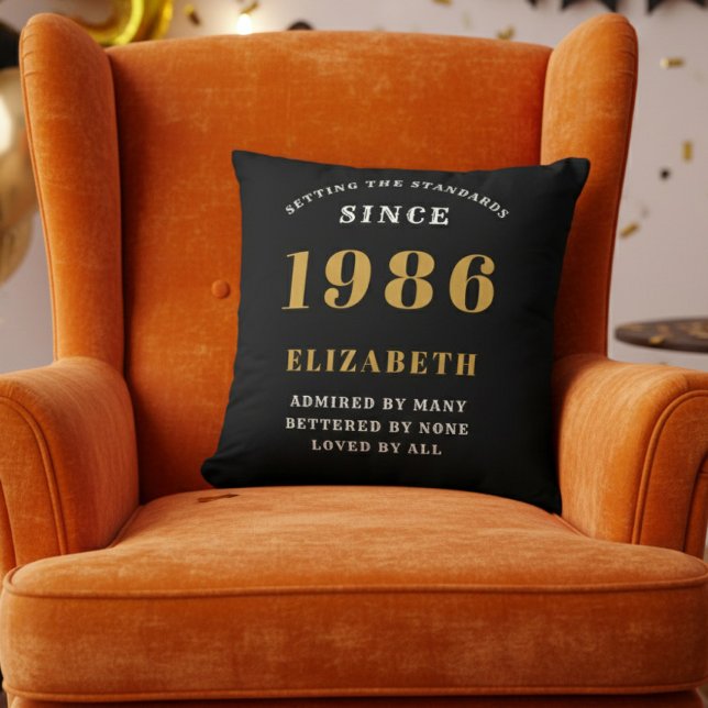 40th Birthday Gift Personalized 1986 Black Gold Cushion (1986 personalized throw pillow on orange chair)