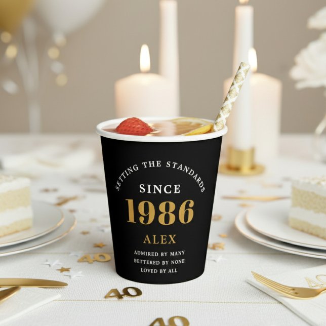 40th Birthday Name 1986 Black Gold Elegant Chic Paper Cups (1986 paper cup on a white and gold decorated table.)