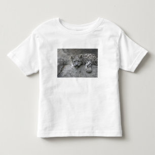 4 month old Snow leopard cub draped over a rock Toddler T-Shirt