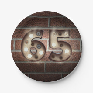65th birthday marquee sign on brick wall paper plate
