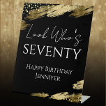 70th Birthday Look Who Gold Black Pedestal Sign<br><div class="desc">Elegant Faux gold foil paint splatters design. All text is adjustable and easy to change for your own party needs. Look Who's Seventy template design. Welcome Sign</div>