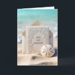 70th Wedding Anniversary Card On Beach Sand<br><div class="desc">A beautifully embossed wedding invitation card rests inside an envelope on the sand near the ocean's edge,  accompanied by a sand dollar for a 70th wedding anniversary.
All text can be changed.</div>