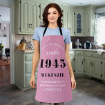 80th Birthday 1945 Name Chic Elegant Pink Apron<br><div class="desc">Elegant pink chic apron - 80th Birthday 1945 Name Personalised Kitchen & BBQ Essentials. Celebrate a fabulous birthday with style and practicality! This elegant chic apron is the perfect accessory for the culinary enthusiast in your life. Its eye-catching design, enhanced with a touch of class, adds a charming vibe to...</div>