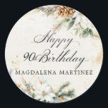 90th Birthday Party White Winter Floral Custom Classic Round Sticker<br><div class="desc">Elegant winter white flowers are nestled in pine greenery and pinecones. The soft ivory white watercolor wash background is accented with gold flecks to create a sophisticated and chic aesthetic.</div>
