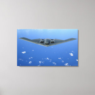 A B-2 Spirit soars through the sky Canvas Print