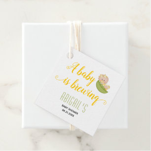 A baby is brewing baby in yellow in a green pod favour tags