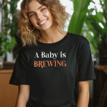A Baby is Brewing in Spooky Cobweb Lettering T-Shirt<br><div class="desc">A Baby is Brewing shirt perfect for mummy-to-be or gender reveal hostess, fall pregnancy announcement or halloween themed baby shower. A Baby is Brewing is lettered in spooky cobweb lettering in orange and white. If you want to change the colours, you can edit using the design tool. Coordinating invitations and...</div>