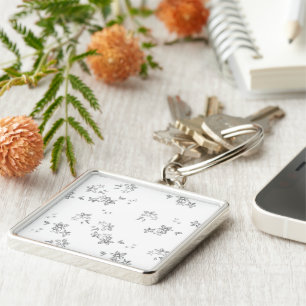 a black and white photo of snow flakes key ring