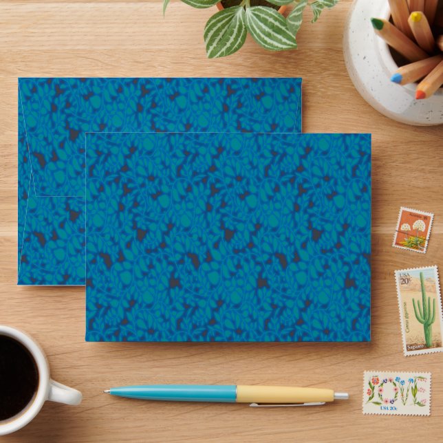 a blue and black background with a pattern envelope (Desk)