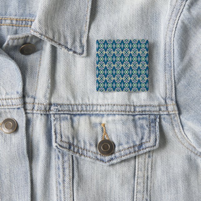 a blue and green pattern with a white background 15 cm square badge (In Situ)