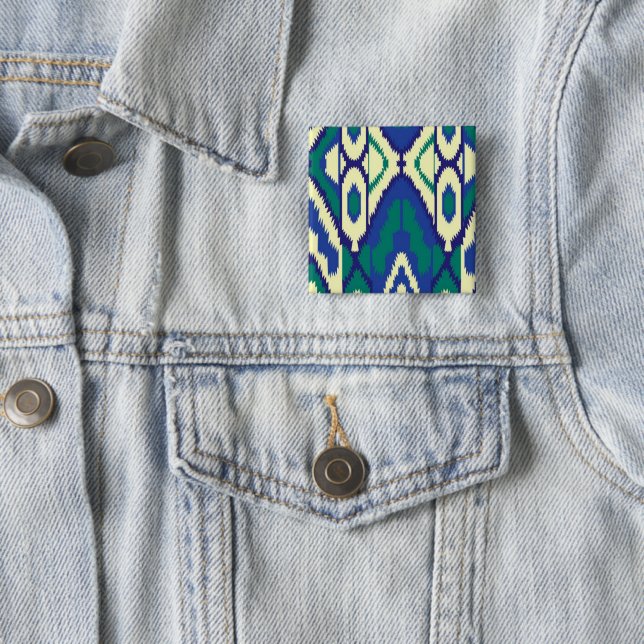 a blue and green pattern with a white background 15 cm square badge (In Situ)