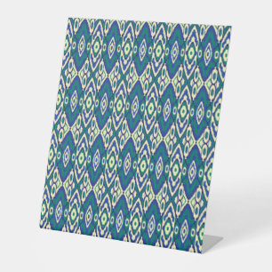 a blue and green pattern with a white background pedestal sign