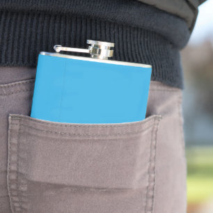 a blue background with a black and white cat hip flask
