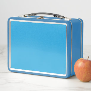 a blue background with a black and white cat metal lunch box
