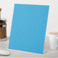 a blue background with a black and white cat on to