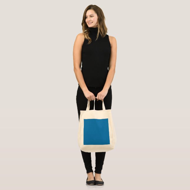 a blue background with a black and white clock tote bag (Front (Model))