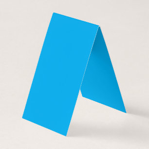 a blue sky with a plane flying in the sky business card