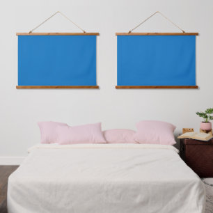 A blue square framed by a white border, showcasing hanging tapestry