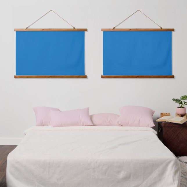 A blue square framed by a white border, showcasing hanging tapestry (Bedroom)