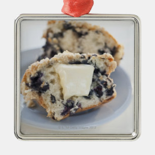 A blueberry muffin with butter metal tree decoration
