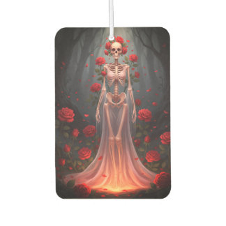 A bony girl wears a wedding dress in a forest.  car air freshener