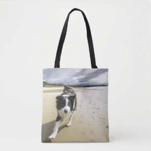 A Border Collie Dog Running On The Beach Tote Bag