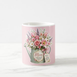 A bouquet of flowers in a watering can for mum coffee mug
